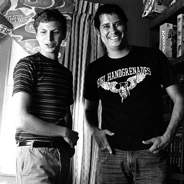 Handsome man standing with Michael Cera on movie set