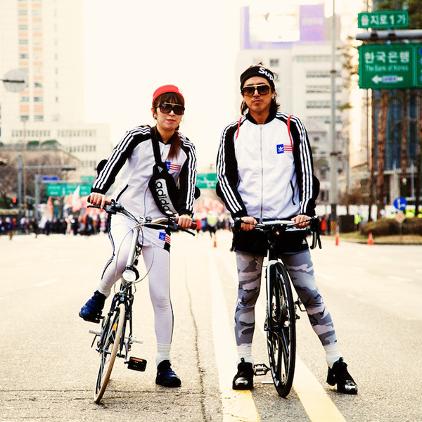 Two bicyclist in the middle of a street in Seoul South Korea