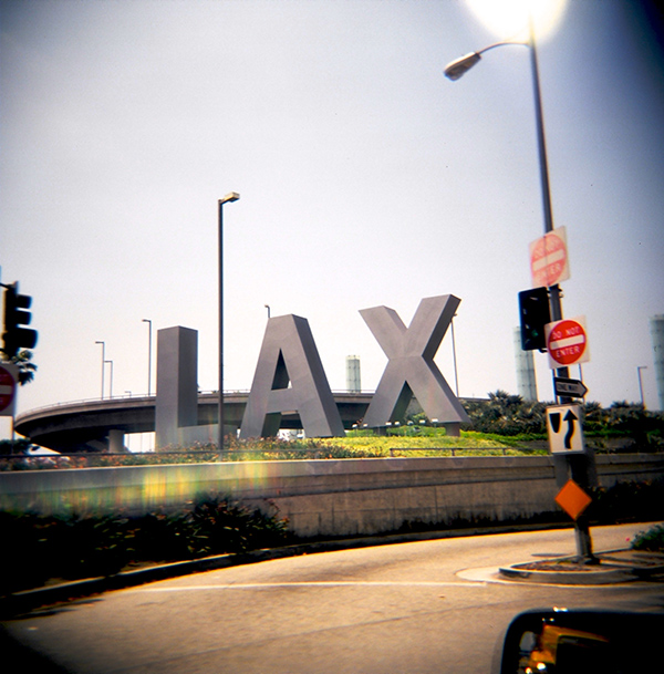 Streetview of Los Angeles Airport LAX sign through window of car